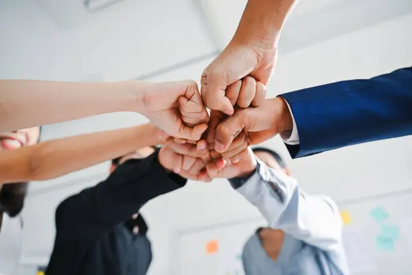 stock image Professional group of business team stacking hands together with teamwork, Business people meeting and brainstorming together at modern office, People discussing and working in creative office. High