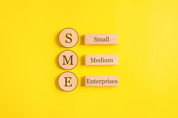 SME, Small Medium Enterprises word on wooden cubes with copy space, Start up small business entrepreneur, Online business marketing. High quality photo