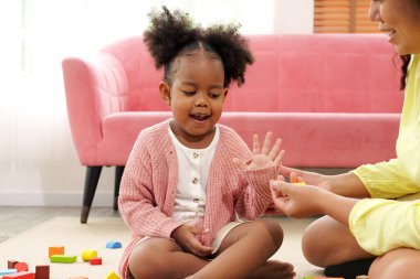 Mutlu anne, kızıyla, ebeveyniyle ve çocuğuyla oyuncak oynayarak, etkinliklerle eğlenerek ve evde oyun oynayarak, hafta sonu evde boş vakit geçirerek vakit geçirir.