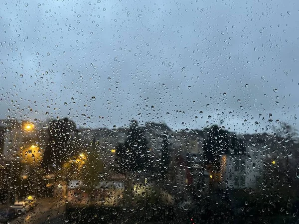 Stadsverlichting Achter Glas Met Regendruppels Rechtenvrije Stockfoto's