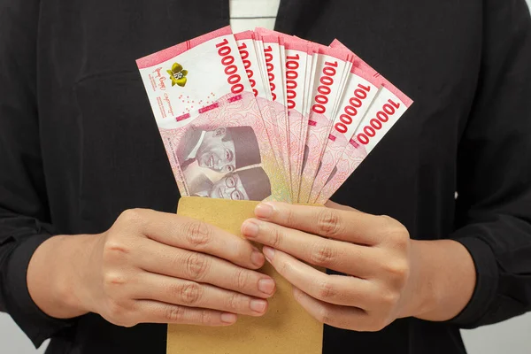 stock image Cash payment concept. Indonesian rupiah currency (Rp. 100.000 Seratus Ribu Rupiah), One hundred thousand Indonesian rupiah money.