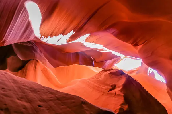 Scenery of bright sun rays falling inside Antelope Canyon and illuminating him. The surface of the rocks in the cave reflects the sun. It is one of the most photographed slot canyons in the world. Popular destinations for hikers
