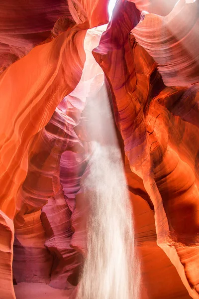 Upper Antelope Canyon in the Navajo Reservation Page Northern Arizona. Famous slot canyon. Falling sand is reflected in the light beam. Unusual colorful sandstone and rock formations in the deserts of Arizona are popular destinations for hikers.
