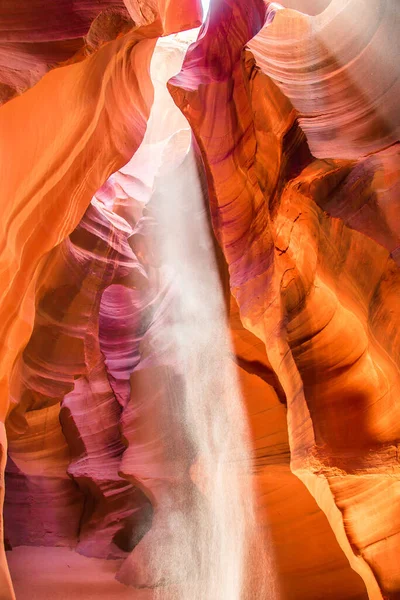 Antelope Canyon in the Navajo Reservation Page Northern Arizona. Famous slot canyon. Falling sand reflected in the light beam. Unusual colorful sandstone and rock formations in the deserts of Arizona are popular destinations for hikers.