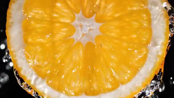 Orange Slice Splashed Water Top Slow Motion Orange Background — Stock Video
