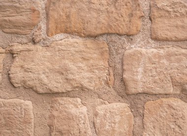 Eski kahverengi taş duvarın arka planı. Yüksek kalite fotoğraf.