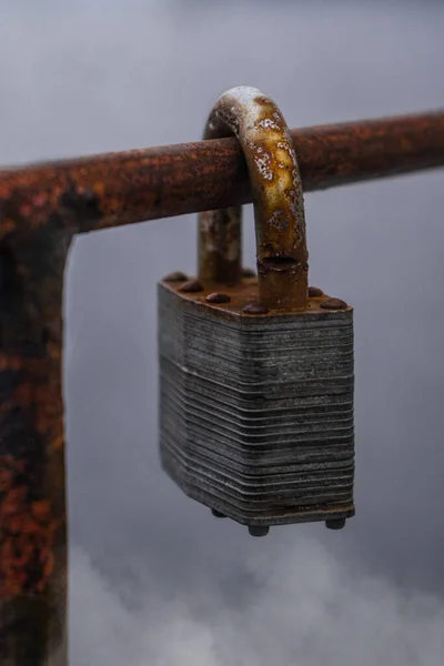 Padlock rusty on a background of fog. High quality photo
