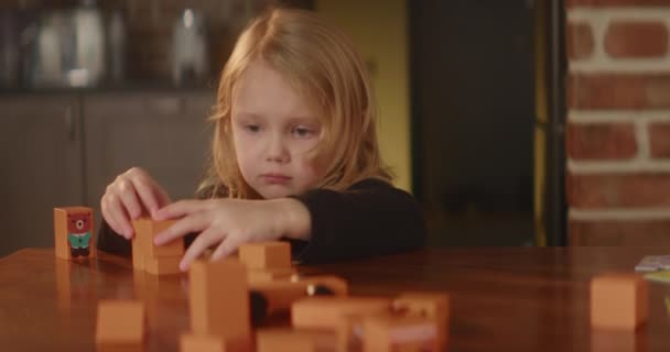 Bored Sad Girl Plays Busily Table Orange Wooden Toy Blocks — Wideo stockowe
