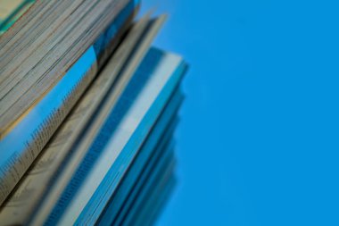 Blue background with stacks of books on the left