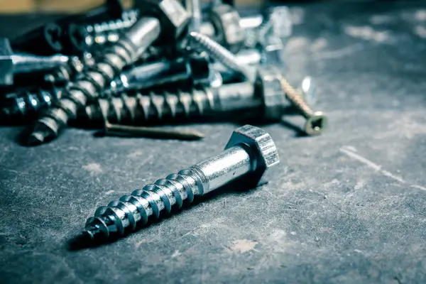 Different Kind of Screws on a table in a workshop