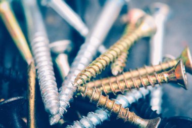 Different Kind of Screws on a table in a workshop