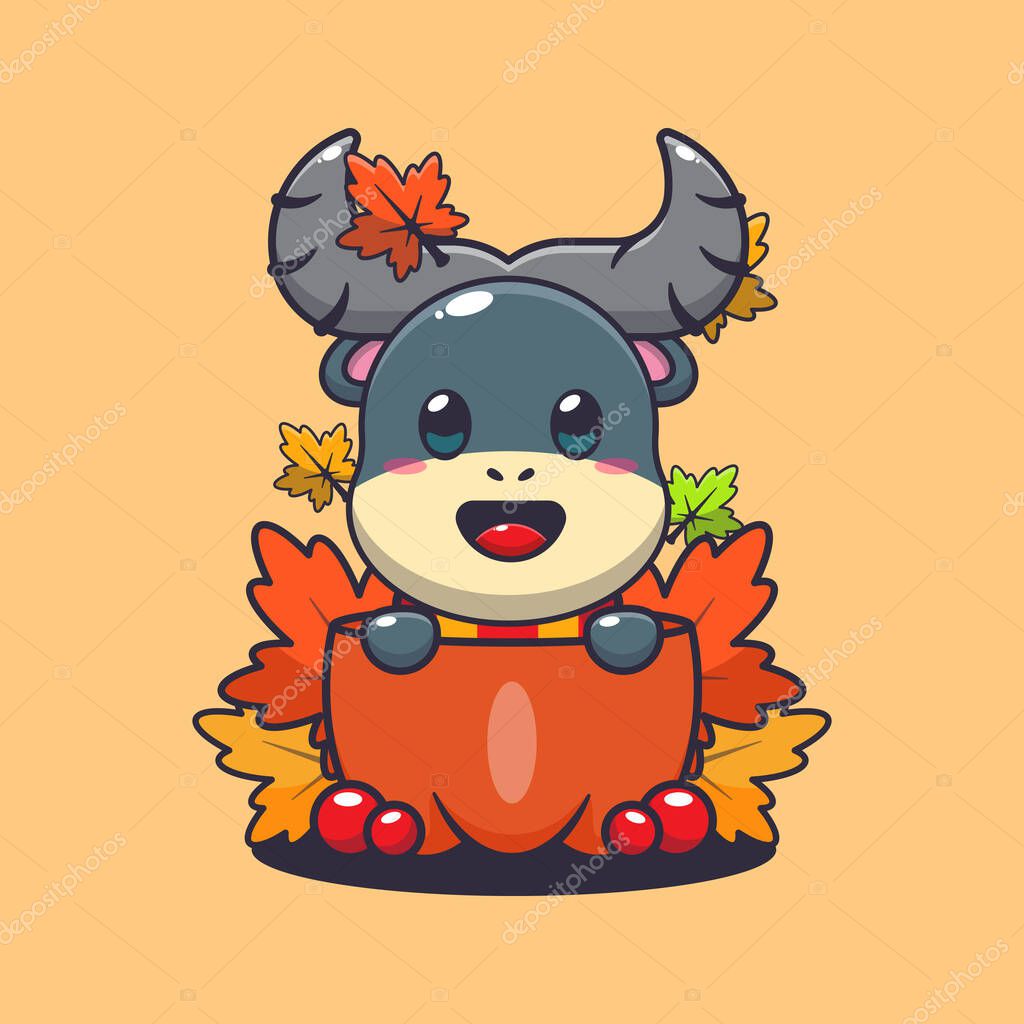 Cute buffalo in a pumpkin at autumn season. Mascot cartoon vector illustration suitable for poster, brochure, web, mascot, sticker, logo and icon.