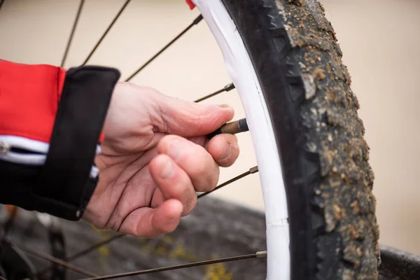 detail of hand closing mountain bike wheel stopper