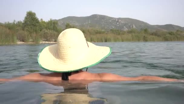 Unrecognizable Woman Bathing River Big Brimmed Panama Hat Landscape Nature — стоковое видео