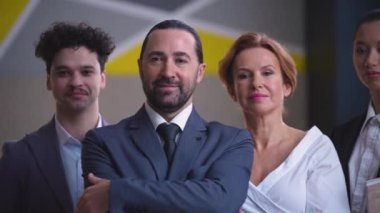 Colleagues, employees, workers in suits with documents looking at camera, team, smiling, camera moving from left to right