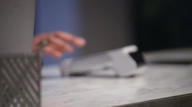 Terminal close-up, male and female hands, customer, attendant, man pays by card, card is applied to the terminal