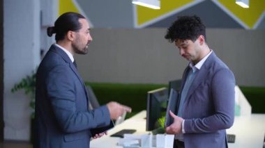 office, the boss scolds the subordinate, the boss is dissatisfied with the work of the employee, two men in suits, close-up