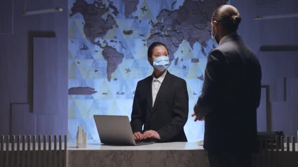 Airport Reception Hotel Woman Administrator Manager Medical Mask Working Desk — Stockvideo