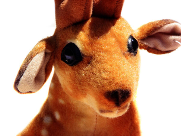 Closeup of a colorful decorated deer doll.