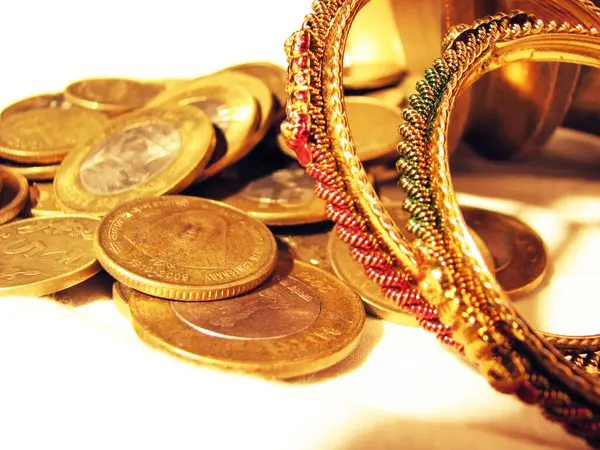 stock image Scattered Indian coins with decorated ornaments.