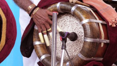 An artist playing Thavil, a South Indian percussion musical instrument. clipart