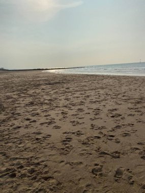 Beach with footprints on on summers day 