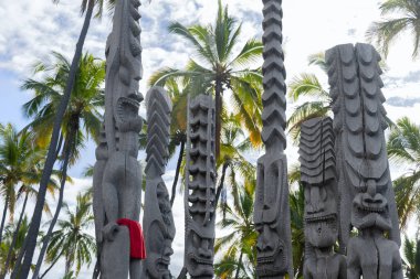 Pantheon of Hawaiian gods represented in form of wooden carved statues. Pu?uhonua o Honaunau national historical park, Hawaii, the USA. clipart