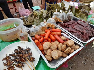 Laos 'taki yerel markette yemek yemeye hazır. Sabah pazarında Lao sokak yemekleri.