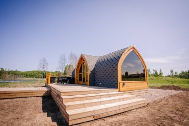 Igloo saunası, gölün kıyısında tahta kaldırımlı.