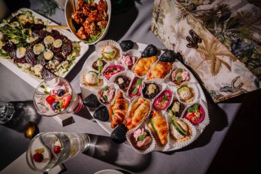 Çeşitli atıştırmalıklar, lezzetli etler, sebzeler, ekmek, pide ve tatlı yemekler.