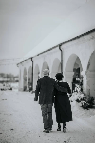 A winter wedding features a radiant senior bride and groom, a mature couple celebrating their love amidst the enchanting backdrop of the season.