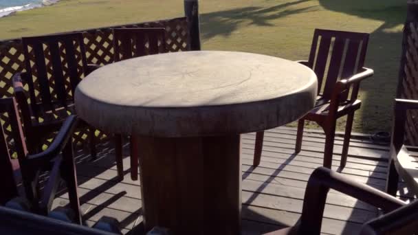 Outdoor Seating Area Stone Table Wooden Chairs Overlooking Sea — Stock Video