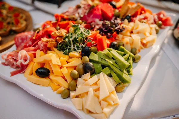 Riga, Letonya - 18 Ocak 2024 - Peynirli, etli, zeytinli ve sebzeli tabaklar.