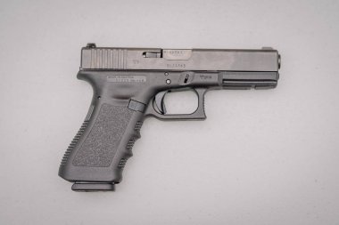 Dobele, Latvia - August 18, 2023 - A Glock pistol on a plain background with visible serial number and markings.