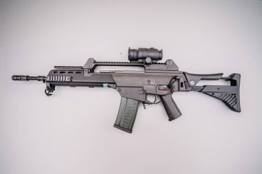 Dobele, Latvia - August 18, 2023 - A black assault rifle with an optical scope on a neutral background.