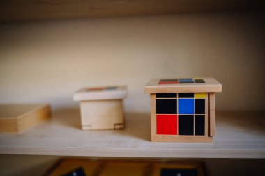 Valmiera, Letonya - 22 Mayıs 2024 - Eğitim amaçlı kullanılan bir rafta Montessori renk küplerinin yakın çekimi. Arka plan bulanık, küplere odaklanmış..