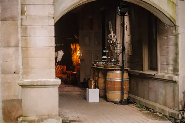 stock image Dobele, Latvia - June 7, 2024 - An archway leads to a cozy interior with vintage furniture and decorative items displayed on wooden barrels.