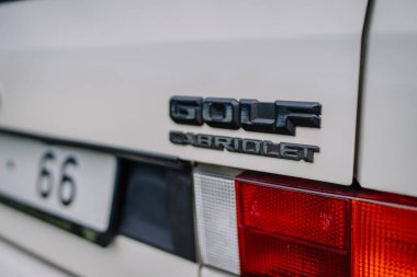 limbazi, Letonya, 29 Haziran 2024 - Bir Volkswagen Golf Cabriolet 'in arkası, model kimlik kartı ve arka lambanın bir parçasını gösteriyor.