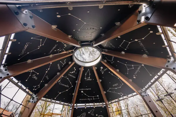 stock image Valmiera, Latvia - April 26, 2024 - An interior view of a space-themed playground structure featuring constellation diagrams and a circular skylight.