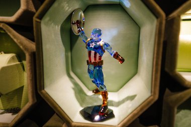 Munich, Germany - September 13, 2024 - A detailed crystal figure of Captain America on display, showcasing vibrant colors and intricate craftsmanship in a well-lit showcase. clipart