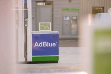 Valmiera, Latvia - August 8, 2024 - Close-up of an AdBlue pump at a modern gas station, offering eco-friendly diesel exhaust fluid service for vehicles. clipart