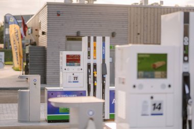 Valmiera, Latvia - August 8, 2024 - Gas station pumps with digital displays and AdBlue options on a sunny day, showcasing modern refueling infrastructure. clipart