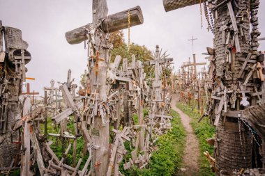 Siauliai, Lithuania, October 21, 2024 A large collection of wooden crosses, crucifixes, and rosaries displayed at Kryzi Kalnas (Hill of Crosses), symbolizing faith, devotion, and pilgrimage. clipart