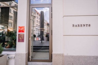 Riga, Letonya - 3 Mayıs 2025 - Barents tabelası olan modern bir restoran girişinin sokak manzarası ve cam kapının yanında asılı kırmızı bir 2025 Michelin plaketi