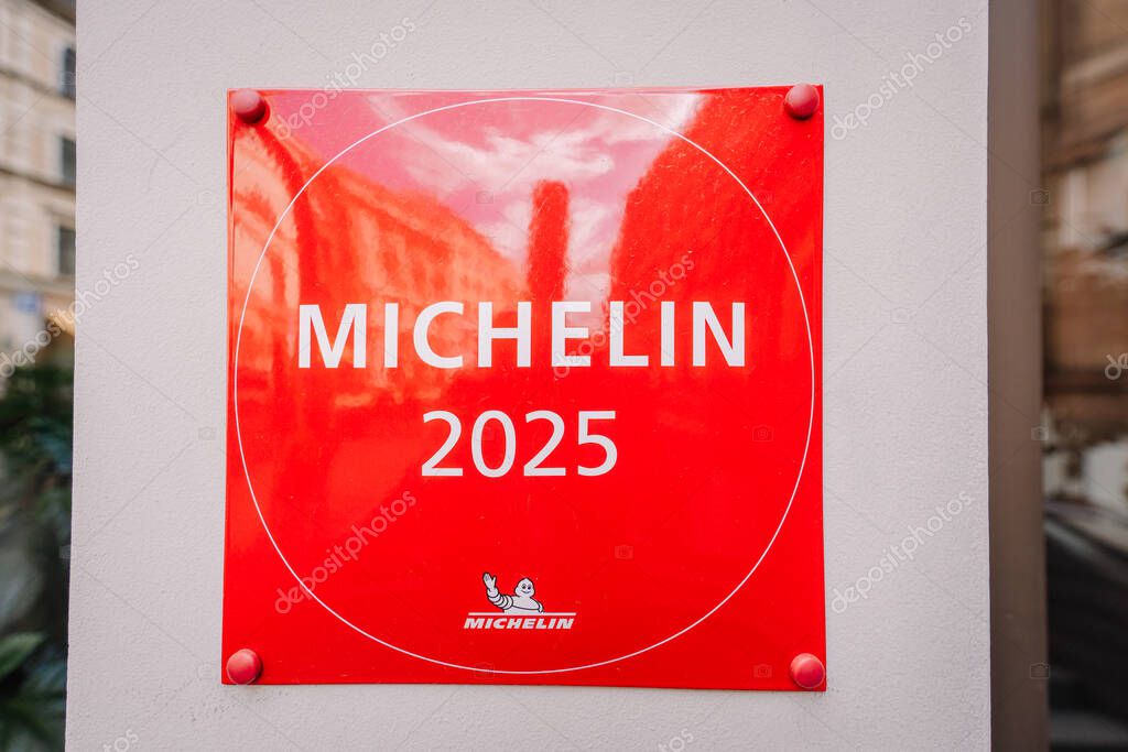 Riga, Latvia - May 3, 2025 - A red plaque with MICHELIN 2025 and the Michelin logo is mounted on a wall, indicating recognition for culinary excellence