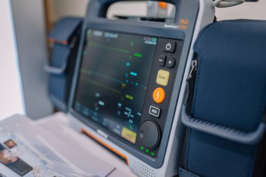 Valmiera, Letonya - 31 Mayıs 2025 - Mindray BeneHeart D60 defibrilatör monitörünün düğmeleri ve yastıklı taşıma çantası ile yakın çekimi.