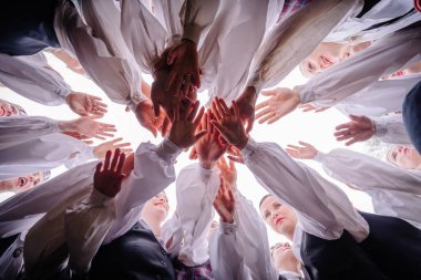 Valmiera, Letonya - 7 Haziran 2025 - Letonyalı halk dansçılarından oluşan bir grup, GAUJA 80 sırasında elleri yukarıda birleşmiş bir birlik çemberi oluşturur..