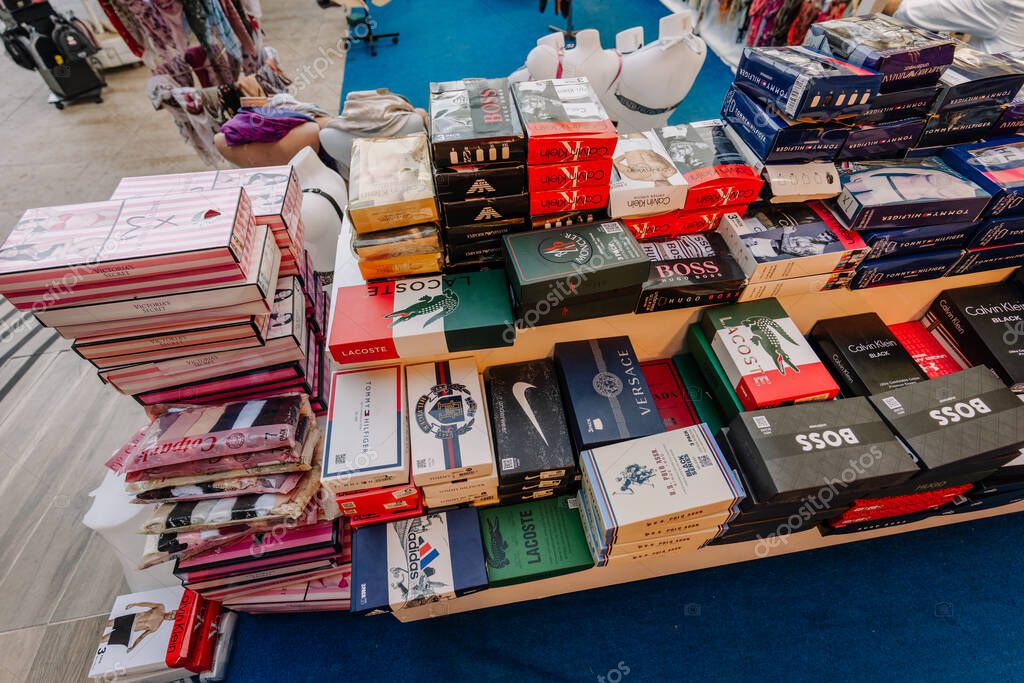 Kemer, Turkey - September 19, 2025 - Boxes of branded underwear, socks, and lingerie are stacked on display in a market stall, showcasing various popular fashion labels.
