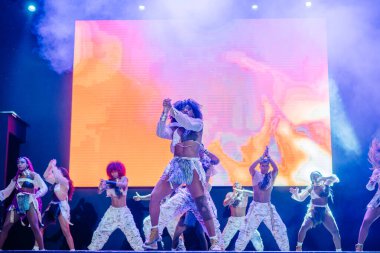 Kemer, Turkey - September 21, 2025 - Raza Urbana dancers perform a vibrant stage show with tribal-inspired costumes and synchronized choreography under dramatic lighting and a vivid digital backdrop.