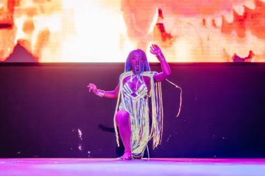 Kemer, Turkey - September 21, 2025 - A Raza Urbana dancer performs solo in colorful fringe costume under dramatic lighting, striking a powerful pose in front of a glowing screen on stage.